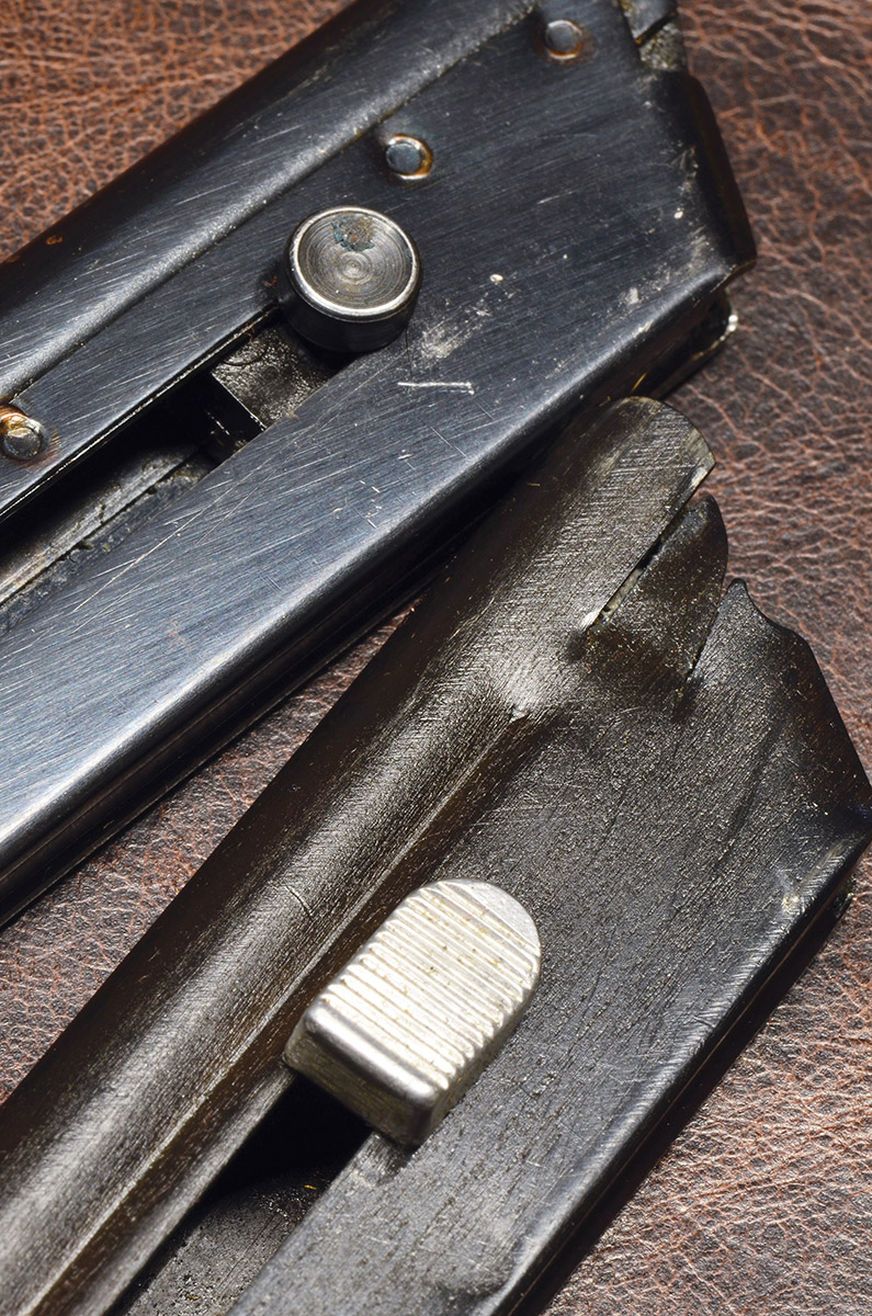 A “Tombstone” clip as issued with the Match  Target (bottom) compared with the standard Woodsman clip (top). The tombstone catch makes loading the magazine considerably easier.